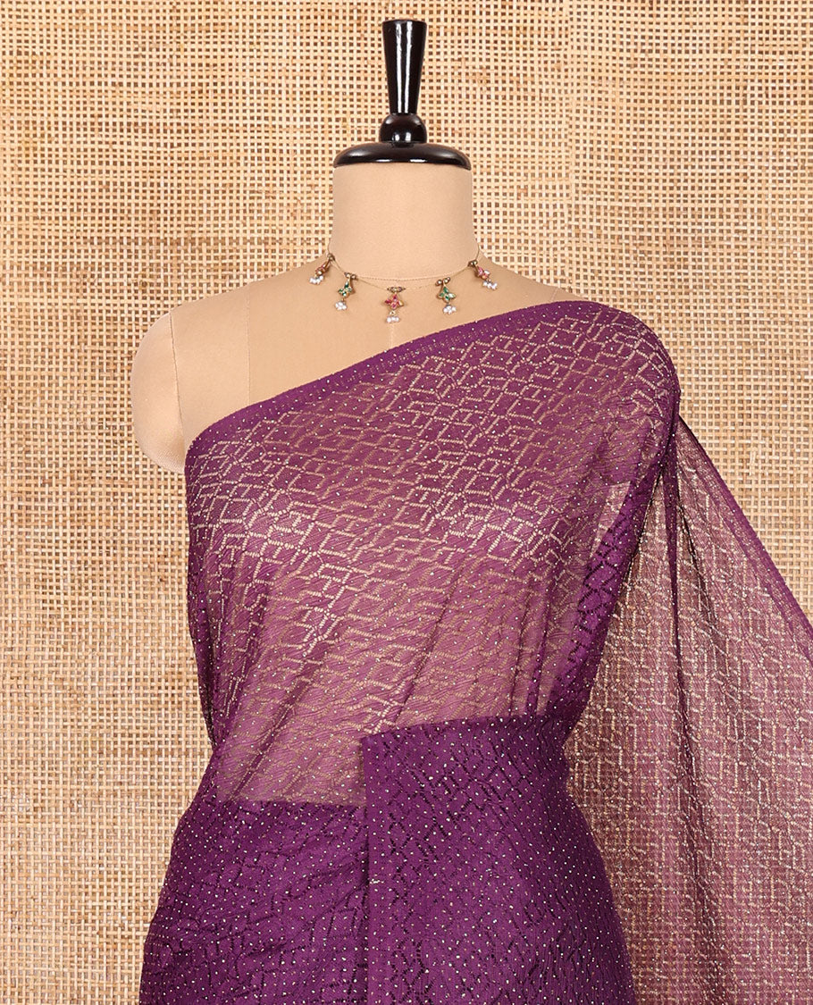 Borderless violet sparkling glitter russel net saree with self-pallu, and a contrast floral printed and zig-zag patterned blouse