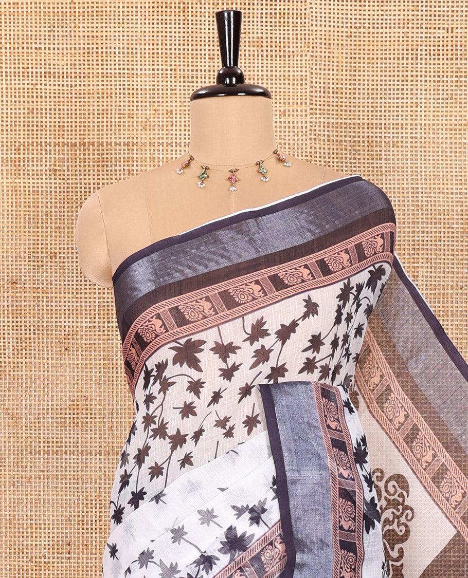 White and Black Linen Cotton Saree Featuring Field Maple Leaf Motifs Printed All Over the Body, Complemented by a Contrast Zari and Peacock-Printed Border, Pallu of Geometric Print, and Paired with a Contrast Checked Blouse