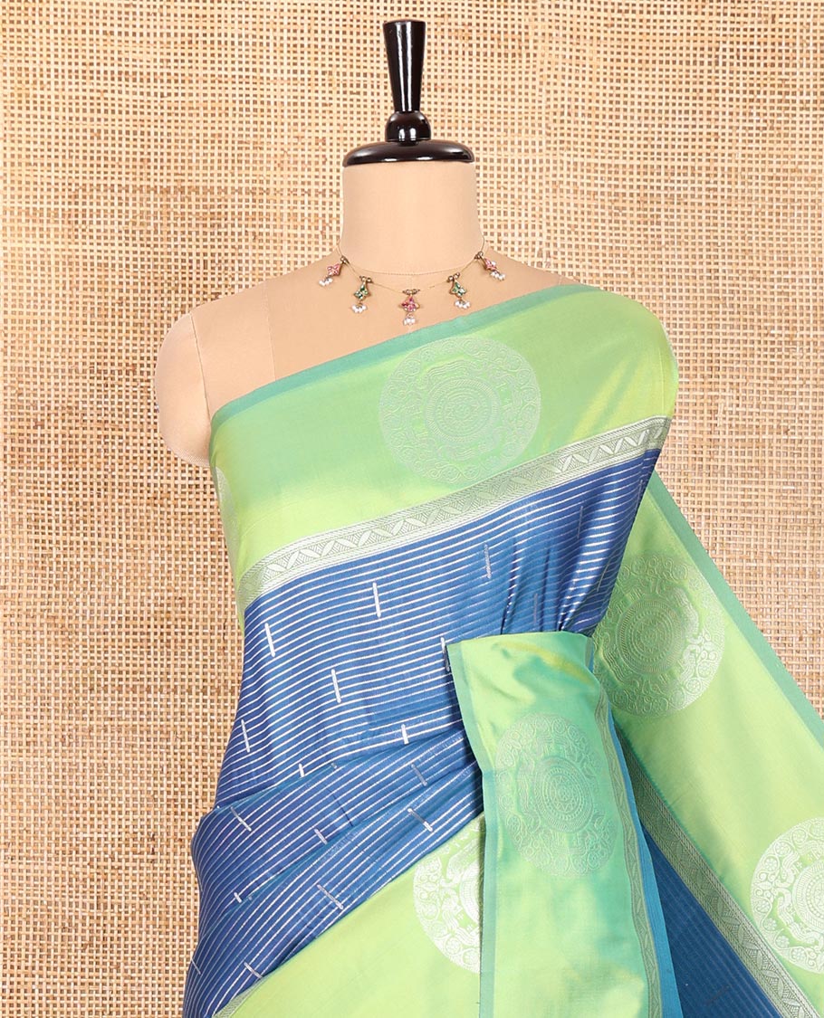 Petrol Blue Elite Soft Silk Saree Ornamented with Vaira Oosi and Zari Buttas All Over Its Body, Complemented by a Contrast Border Featuring Chakram Motifs, Subtly Sparkled Pallu, and Paired with a Contrast Blouse