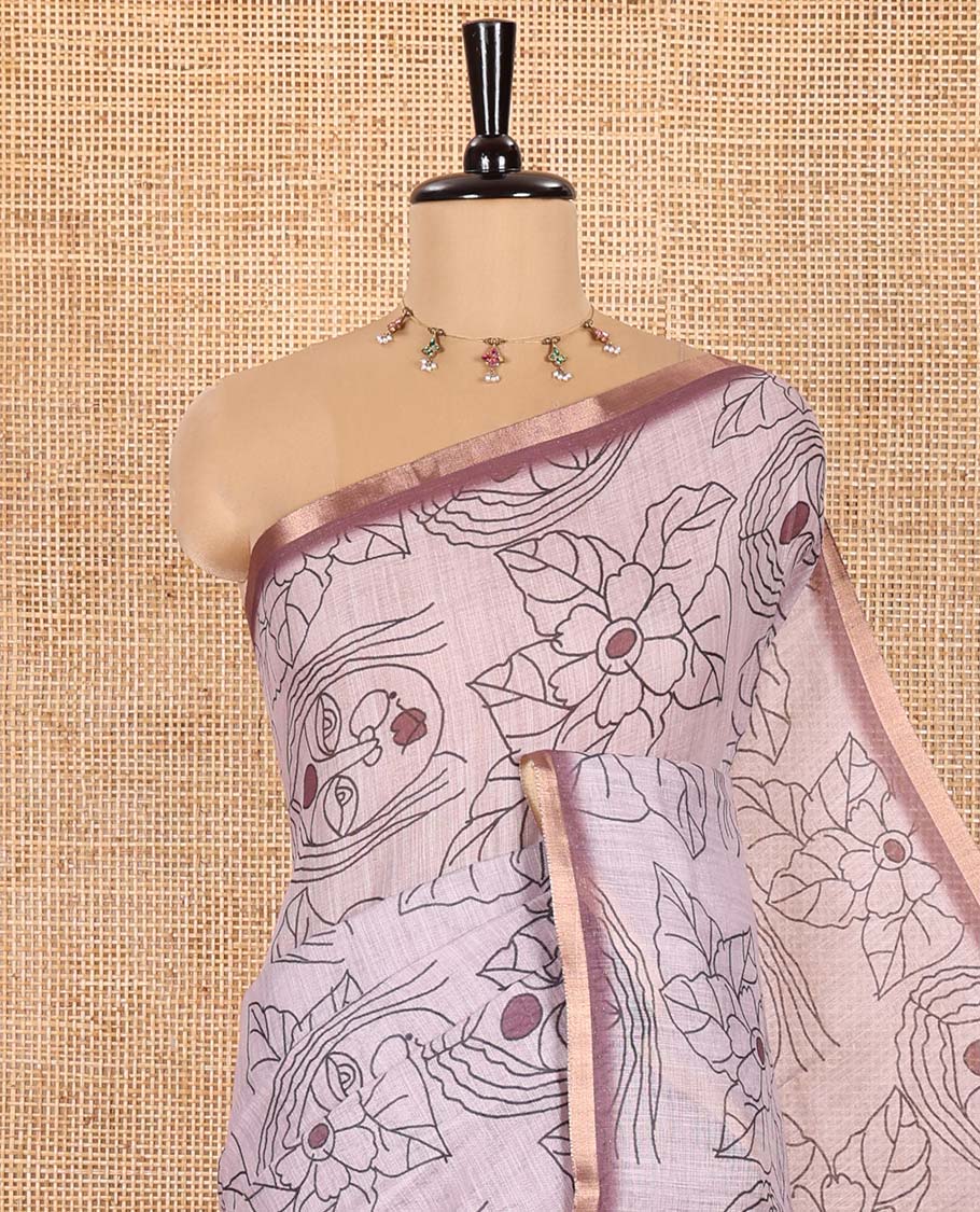 Light Mauve Linen Saree Creatively Printed with Girl Face and Floral Motifs All Over Its Body, Subtly Sparkled with Piping Zari Border, Pallu Mirrors the Same Body Print, and Paired with a Contrast Blouse