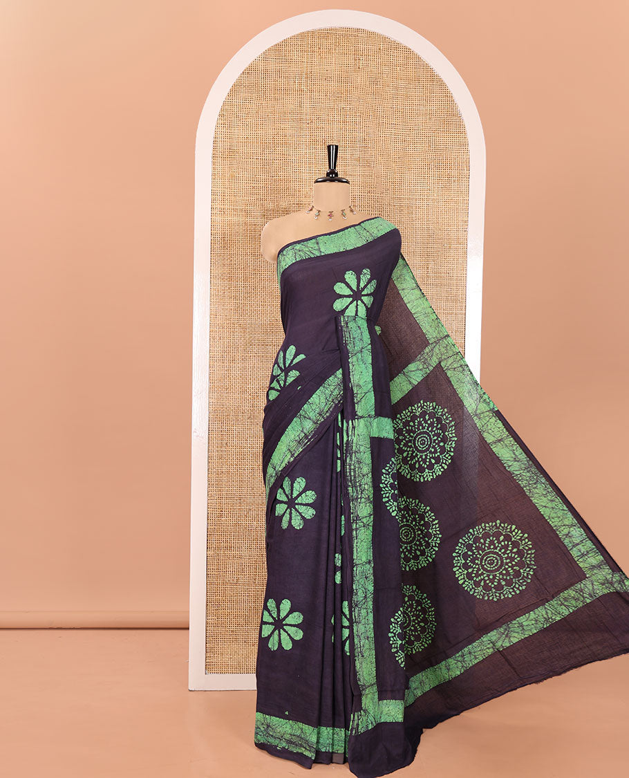 Blue Mul Cotton Saree Beautified with Batik-Style Floral Motifs Printed All Over Its Body, Complemented by a Contrast Batik Printed Border, Pallu Mirrors the Same Batik Print, and Is Paired with a Matching Blouse