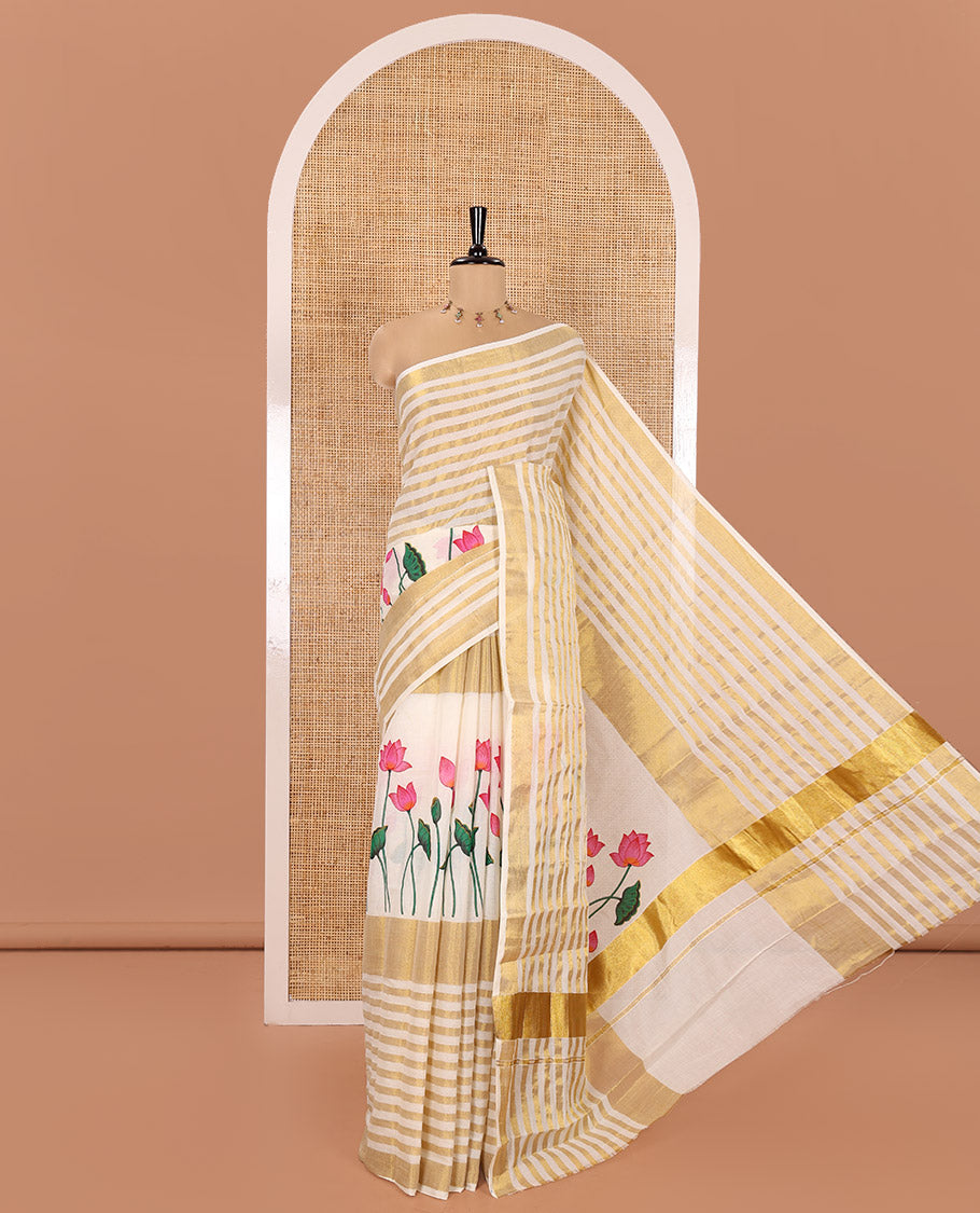Cream Kerala Cotton Saree, Gleamed Up with Horizontal Zari Stripes and Pichwai Lotus Print All Over Its Body, Subtle Zari Border, Pallu Mirrors Pichwai Lotus Print, and Paired with a Matching Blouse