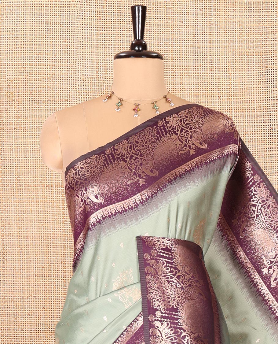 Pista Green Elite Soft Silk Saree, Featuring Zari Buttas on Its Body, Complemented by a Contrast Peacock-Floral Zari Blouse, Intricately Designed Pallu, and Paired with a Contrast Blouse