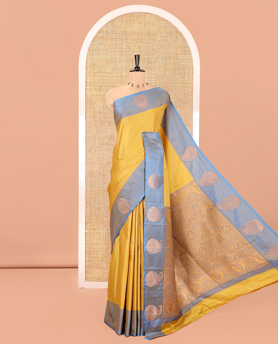 Mehendi Green Kanchi Soft Silk Saree, Majestically Detailed with Vaira Oosi, and Zari Buttas All Over Its Body, Complemented by Contrast Border of Paisleys, an Intricately Designed Pallu, and Paired with a Contrast Blouse