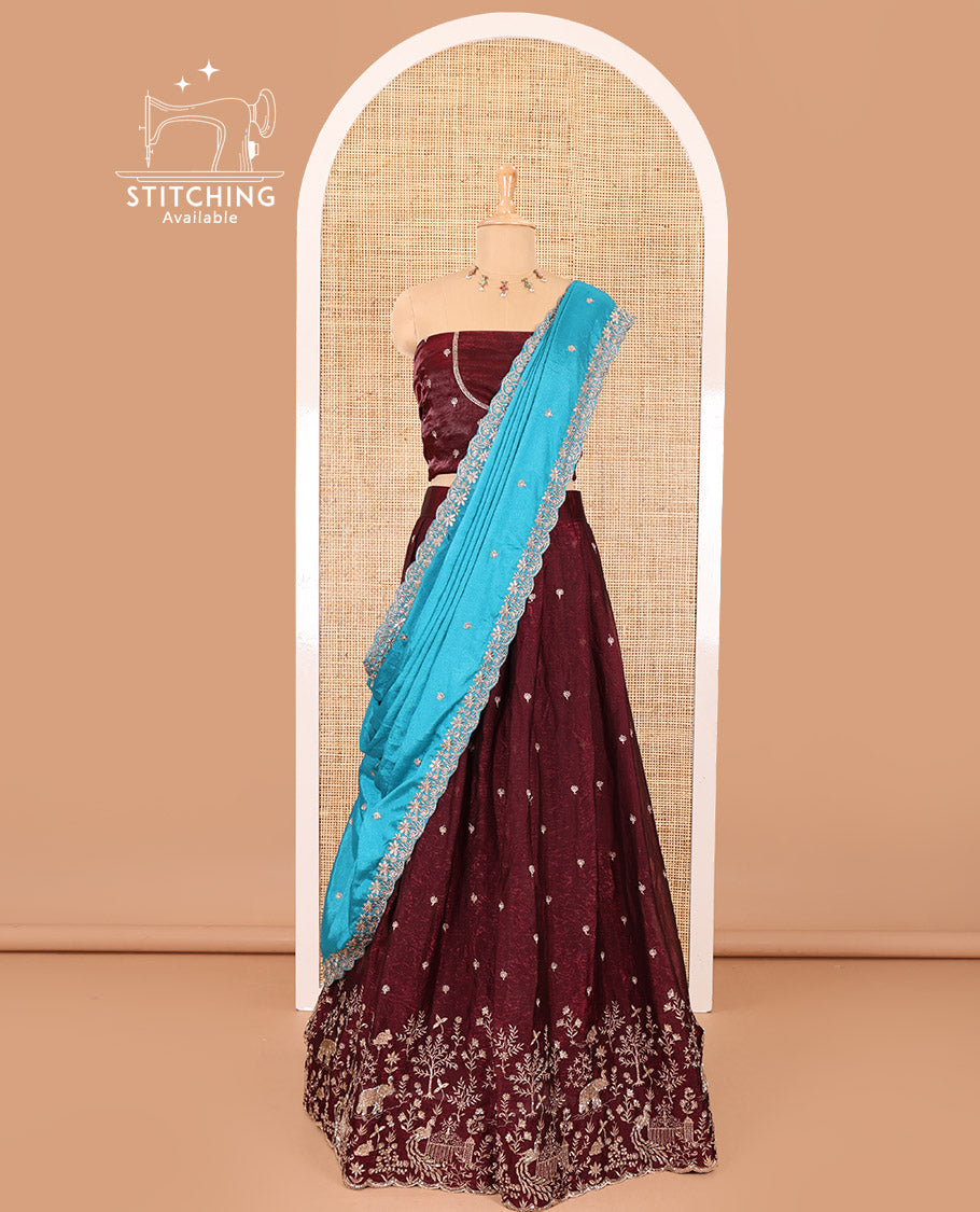 Wine half-saree, buttas and flora-fauna embroidered bordered velvet organza skirt, a matching velvet organza blouse, and a contrast embroidered scallop syska georgette dhavanif