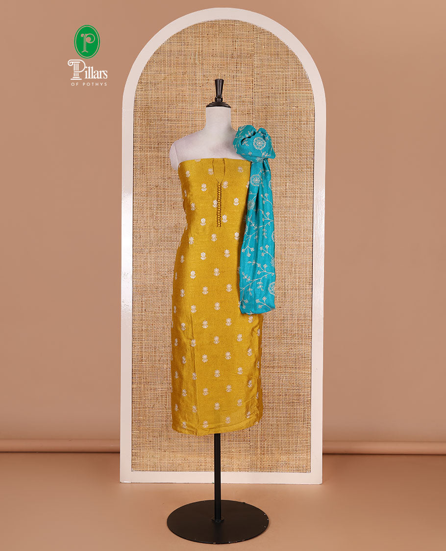 Mustard Vichitra silk material churidar set, floral motifs embroidered top, contrast Santoon bottom, and floral vine thread embroidered scallop dupatta