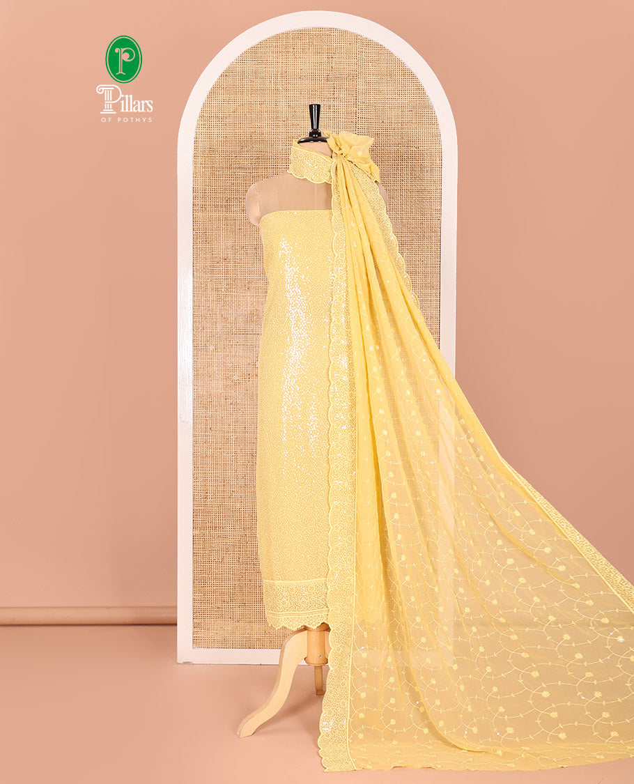 Yellow Material Chudidar Set Features Sequin Embroidered Georgette Top, a Plain American Crepe Bottom, and a Scallop Dupatta Embellished with Floral Vine Embroidery