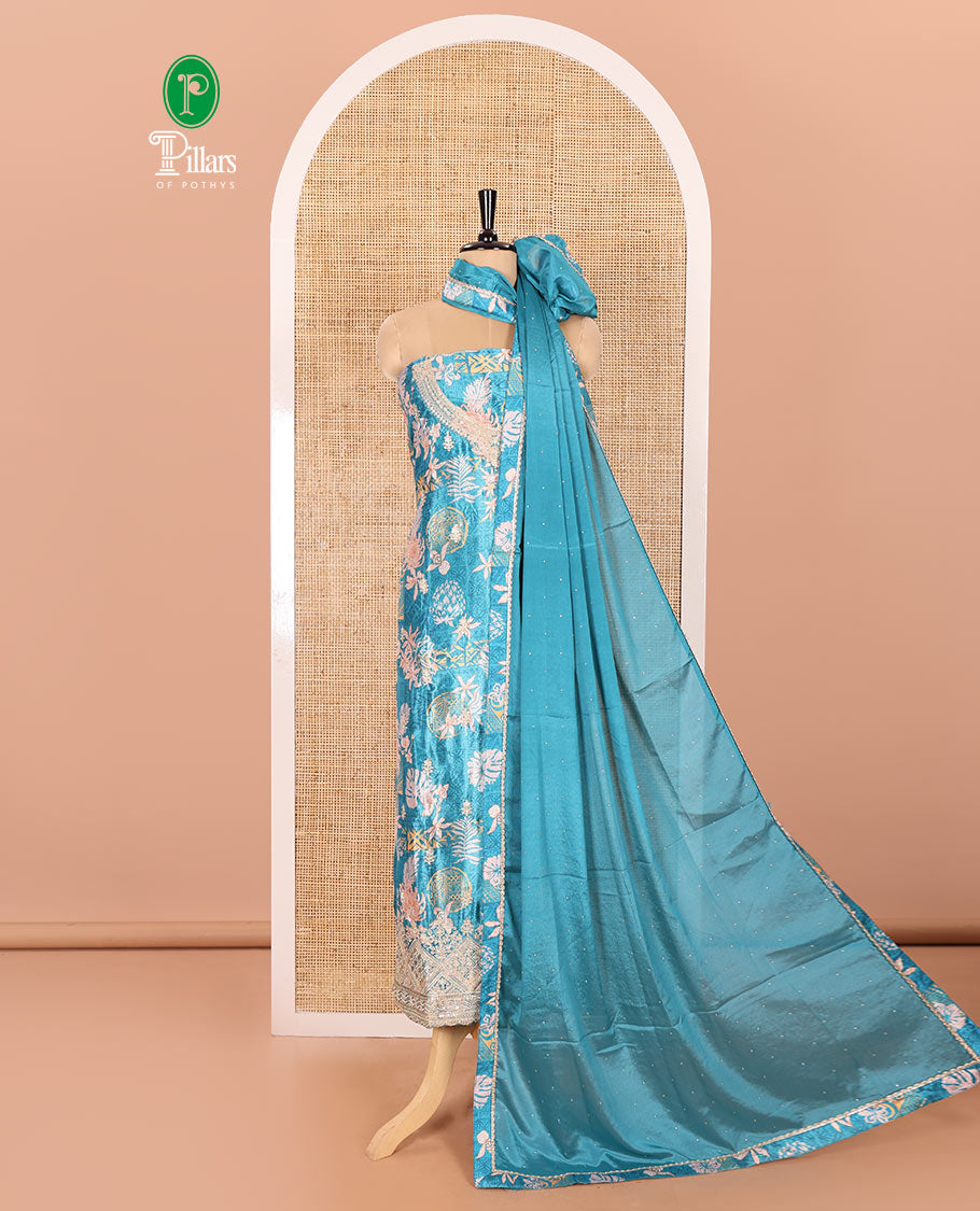 Blue Material Chudidar Set Embellished with Floral-Geometric Printed with Neck Embroidered Chinon Top, Subtly Made Plain Santoon Bottom, and a Chinon Dupatta Featuring Printed Border, and Glitter Dots