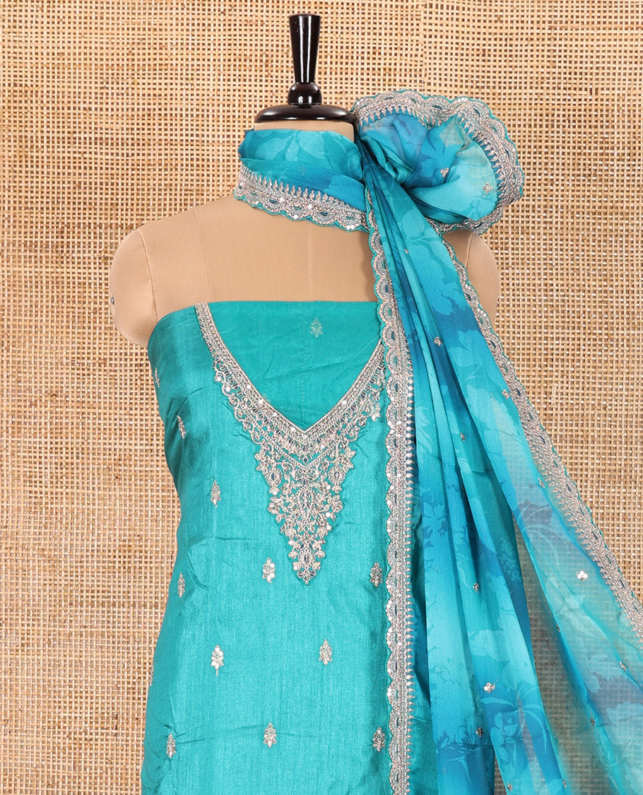 Green Material Chudidar Set Prettified with Intricately Embroidered Muga Silk Top, Subtly Made Plain Santoon Bottom, and a Bemberg Chiffon Dupatta Featuring Floral Printed, and Embroidery