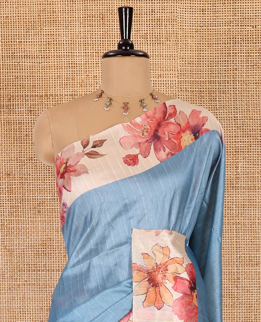 Blue plain fancy tussar digital printed saree, contrast floral digital printed border, floral printed pallu, and a floral printed blouse