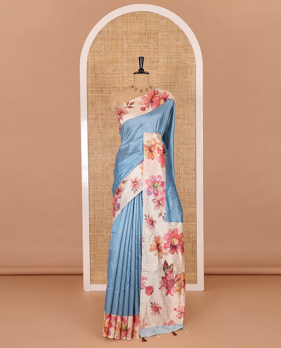Blue plain fancy tussar digital printed saree, contrast floral digital printed border, floral printed pallu, and a floral printed blouse