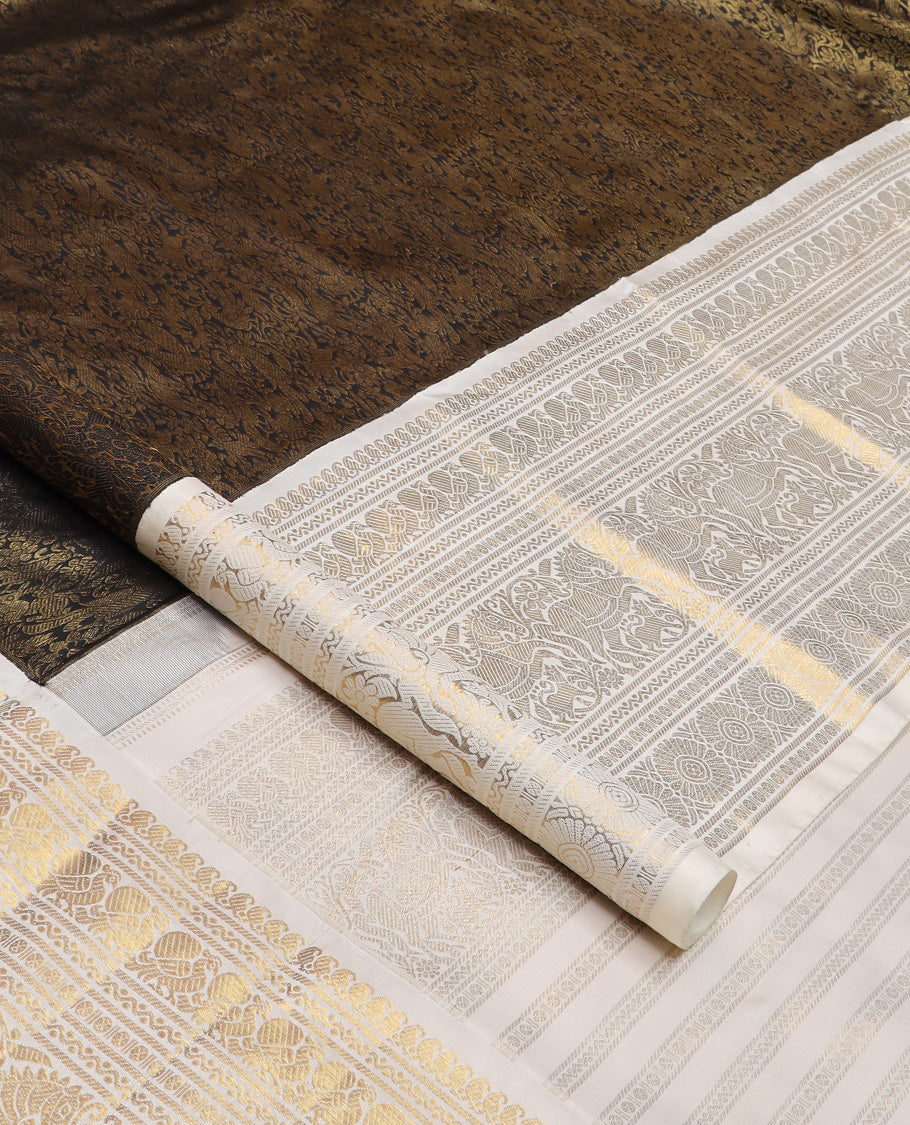 Black jacquard Kanchipuram silk saree, contrast korvai border of manga mokku, neli, banaras, mayil, kuthirai, poun, and poo chakram designs, and zari-rich pallu