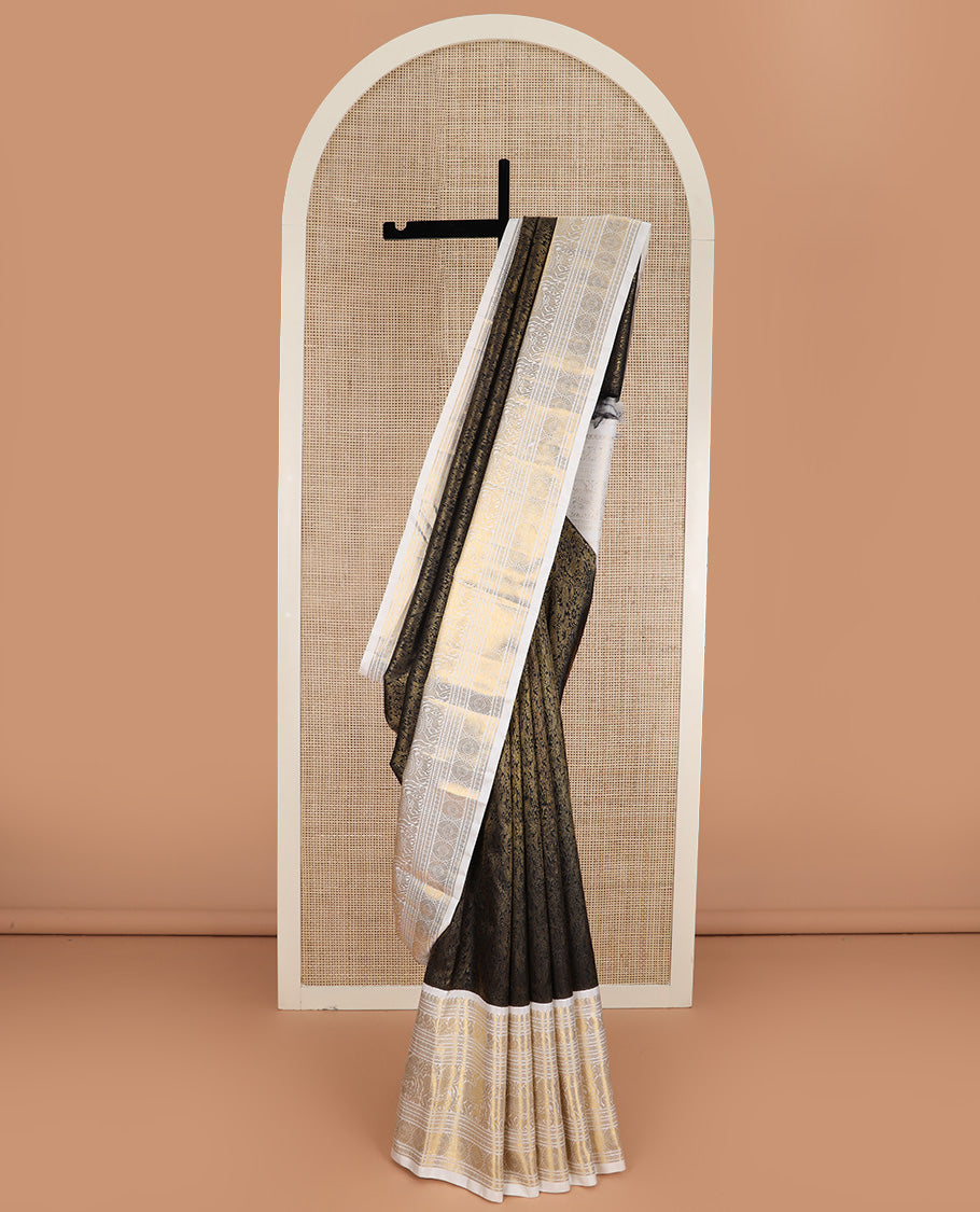 Black jacquard Kanchipuram silk saree, contrast korvai border of manga mokku, neli, banaras, mayil, kuthirai, poun, and poo chakram designs, and zari-rich pallu