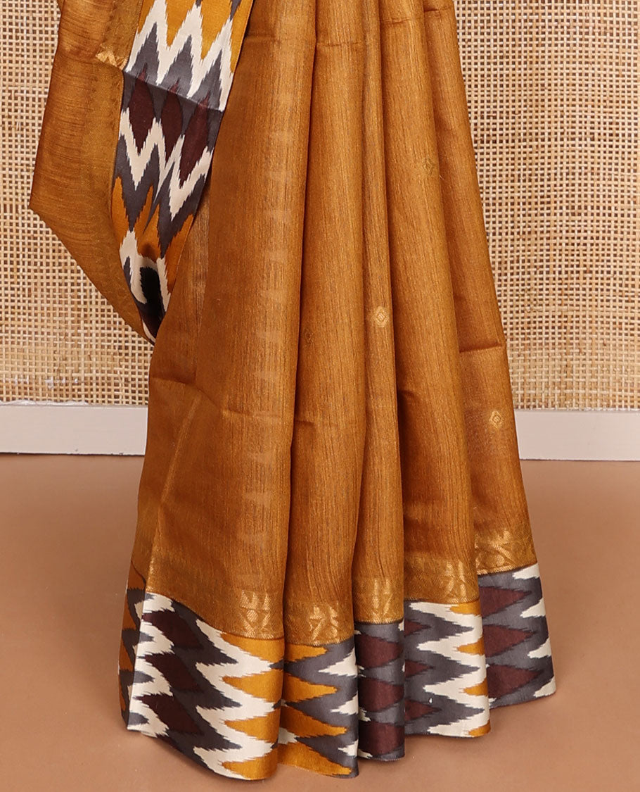 Mustard tussar saree with buttas, contrast pochampally ikkat-style geometric patterned border & pallu