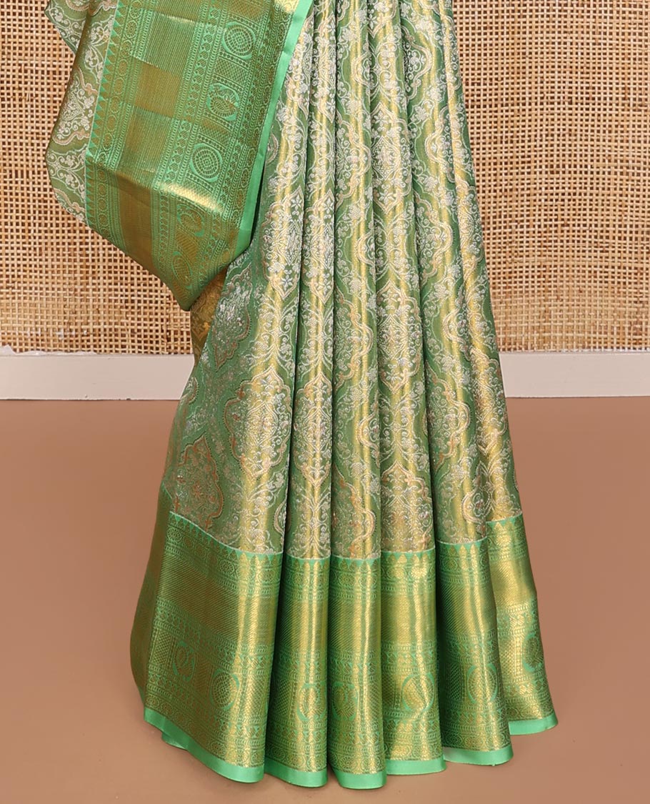 Green Kanchipuram Tissue Silk Saree, Elevated with Jacquard Design on Its Body, Complemented by a Contrast Border of Rekku, Kamalam, Banaras, Muthu, Manga, Mayil, and Mayil Kann Designs, Grand Ogee Pallu, and Paired with a Contrast Blouse