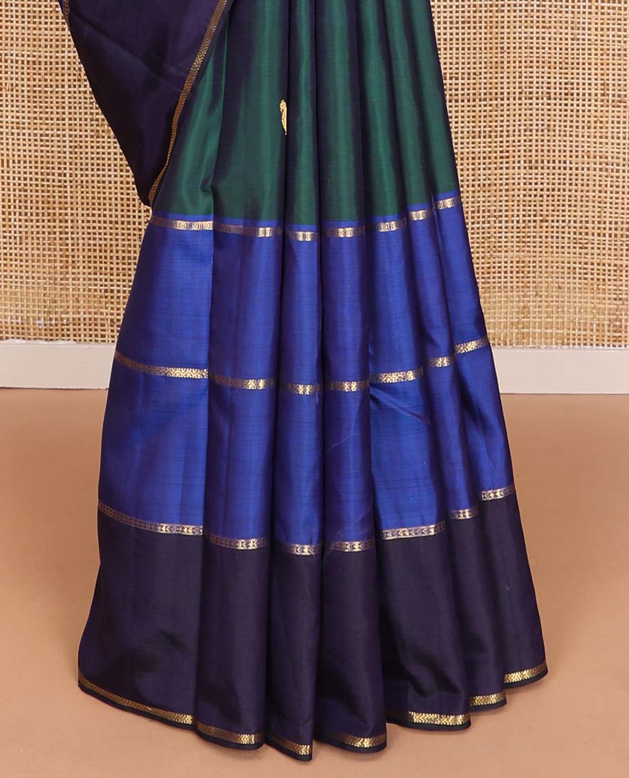Green kili buttas Kanchipuram silk saree, contrast border of lavangam, muthu, neli, ara bogudi, and kathir stripes, and kathir design pallu