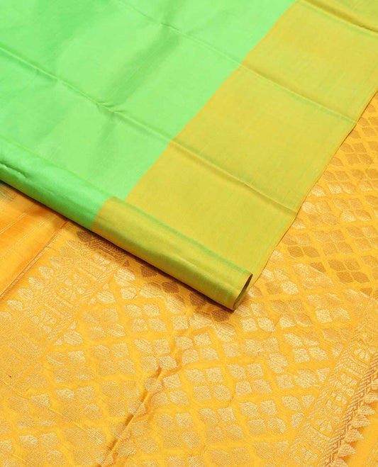 Light green kancheepuram silk sare with contrast floral design border & argyle design pallu