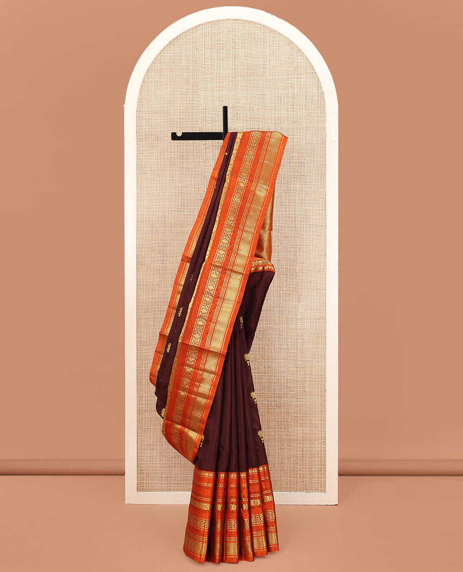 Brown Venkatagiri Silk Saree, Spotlighted with Zari Buttas All Over Its Body, Complemented by a Contrast Border of Temple, Floral, and Peacock-Eye Designs, Pallu of Peacock Eye Designs, and Paired with a Contrast Blouse