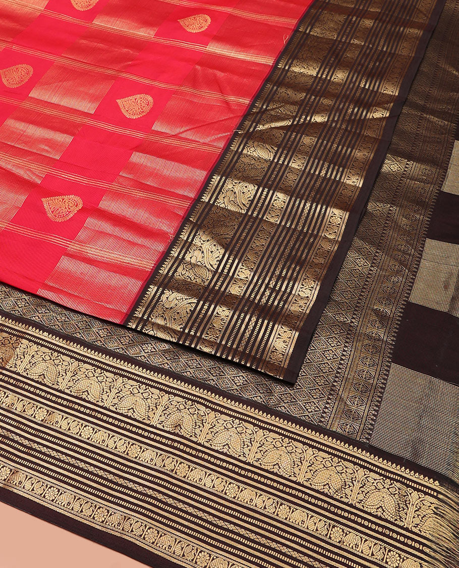 Red Vasundhara Silk Saree, Accentuated with Zari Buttas and Zari Stripes All Over Its Body, Complemented by a Contrast Border of Thilakam, Banaras, Muthu, Yaanai, Manga, and Mayil Designs, Zari Elevated Jaal Pallu, and Paired with a Contrast Blouse