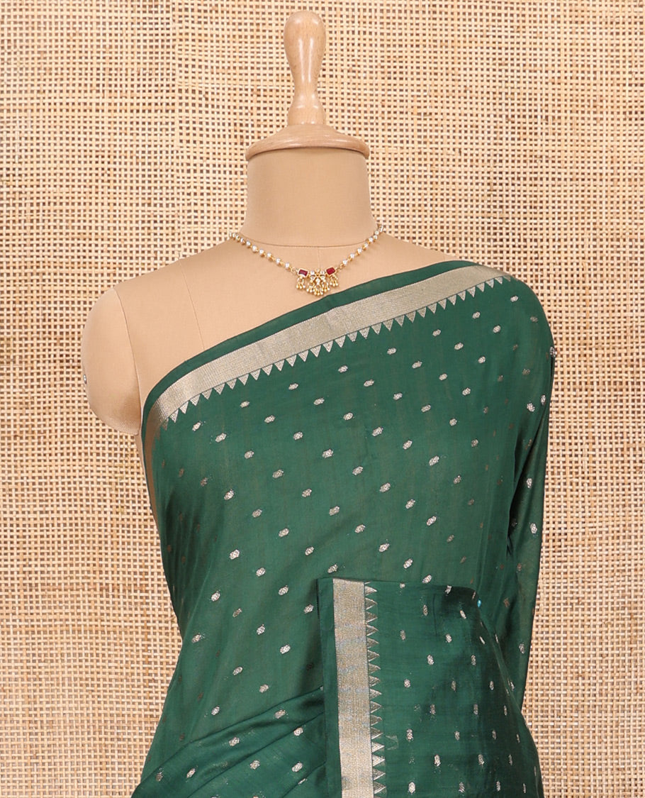 Green Assam Silk Saree Features Bright Zari Buttas All Over Its Body, a Subtle Temple Zari Border, a Pallu Highlighted with Zari Stripes, and Comes with a Matching Blouse