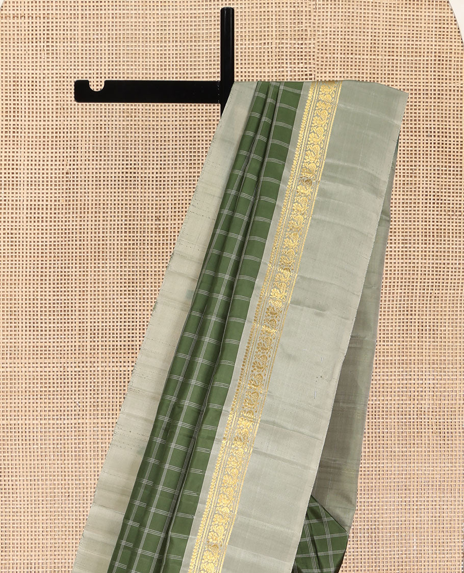 Olive Kanchipuram Silk Saree, Enthralled with Medium-Sized Checked Design All Over Its Body, Complemented by a Contrast Kal Eragina Border of Thilakam Mokku, Banaras, Muthu, and Mayil Designs, Subtly Striped Pallu, and Paired with a Contrast Blouse