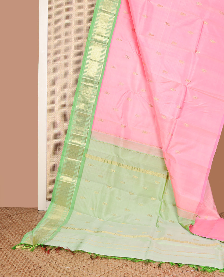 Pink zari buttas Kanchipuram silk saree, contrast one-sided border of paneer sombu, banaras, muthu, and jaal design, and zari woven pallu