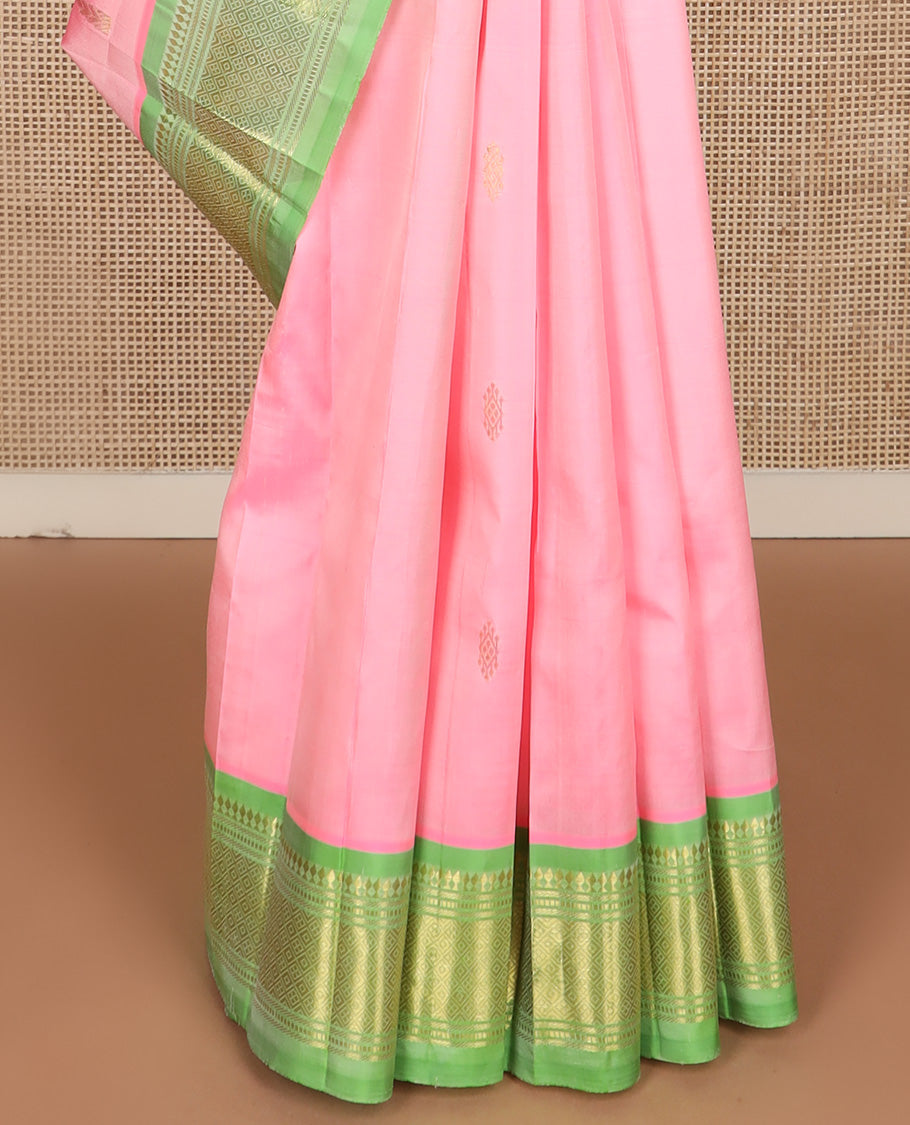 Pink zari buttas Kanchipuram silk saree, contrast one-sided border of paneer sombu, banaras, muthu, and jaal design, and zari woven pallu