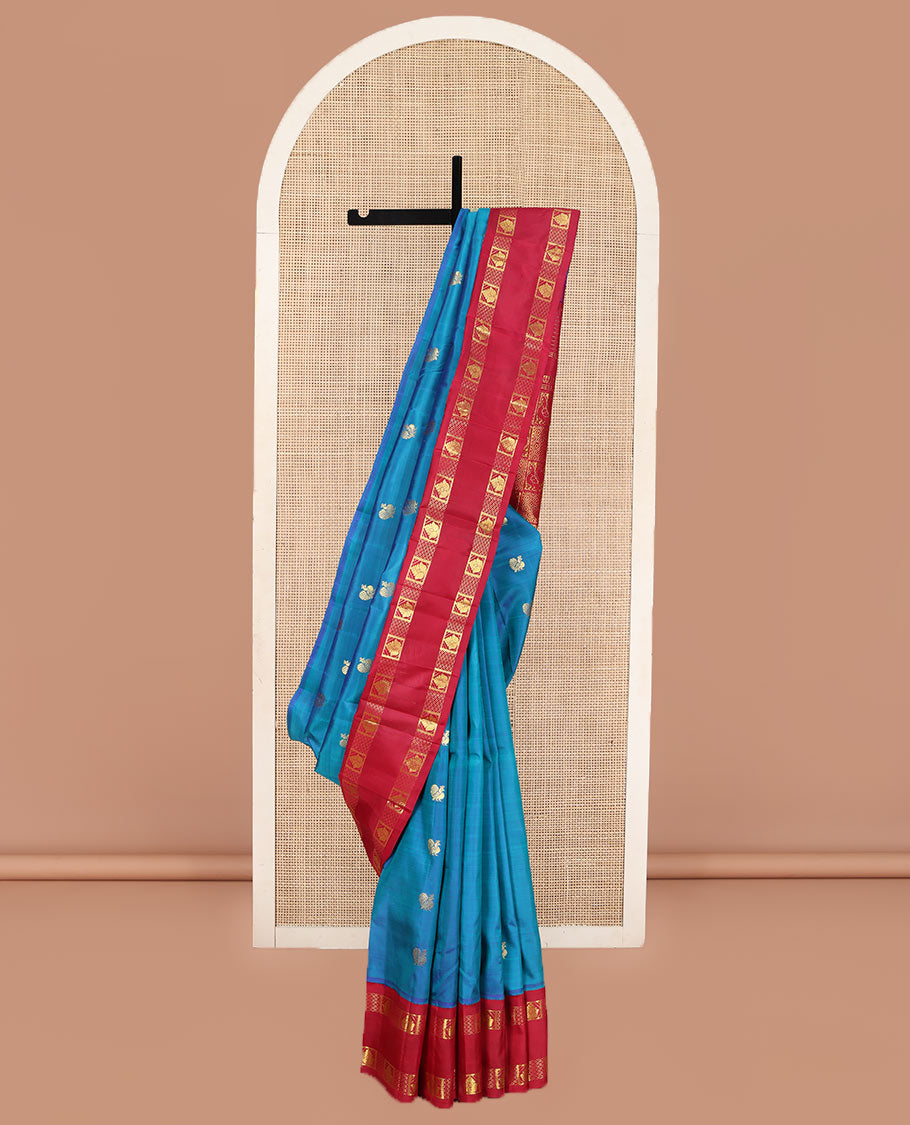 Blue Kanchipuram Silk Saree, Decked Up with Mayil Buttas on Its Body, Complemented by Contrast One-Sided Korvai Traditional Zari Border, Pallu Features Jaal and Mayil Designs, and Comes Without a Blouse