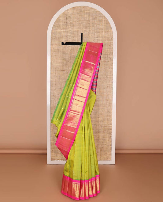 Green kancheepuram silk saree with zari buttas, contrast one-sided korvai border of salngai, banaras & mayil kann & zari-rich pallu of kodi visiry designs