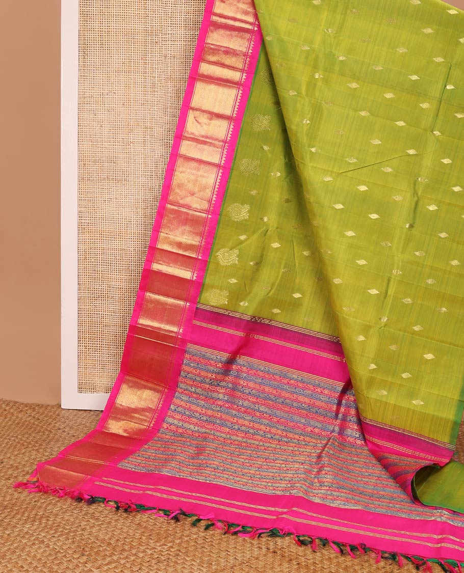 Green kancheepuram silk saree with zari buttas, contrast one-sided korvai border of salngai, banaras & mayil kann & zari-rich pallu of kodi visiry designs