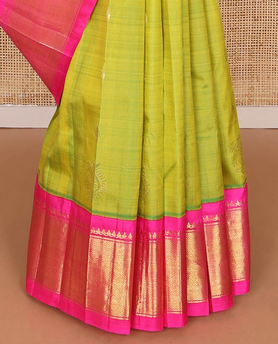Green kancheepuram silk saree with zari buttas, contrast one-sided korvai border of salngai, banaras & mayil kann & zari-rich pallu of kodi visiry designs