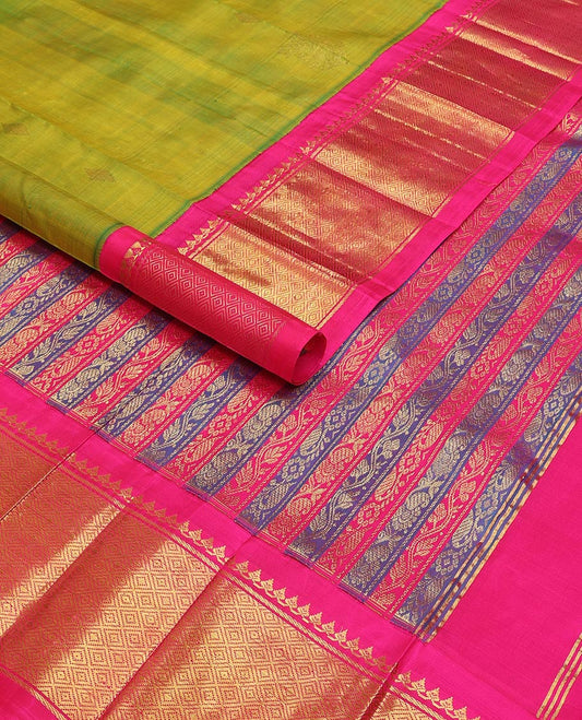 Green kancheepuram silk saree with zari buttas, contrast one-sided korvai border of salngai, banaras & mayil kann & zari-rich pallu of kodi visiry designs