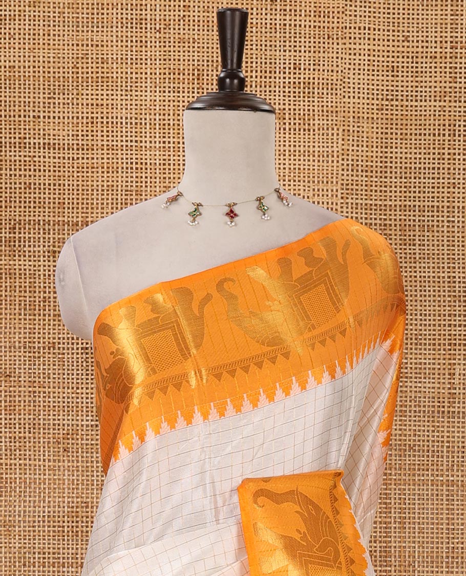 White checked semi-tafeta saree, contrast temple zari elephant motifs orange color border, zari-rich pallu & contrast checked zari border blouse