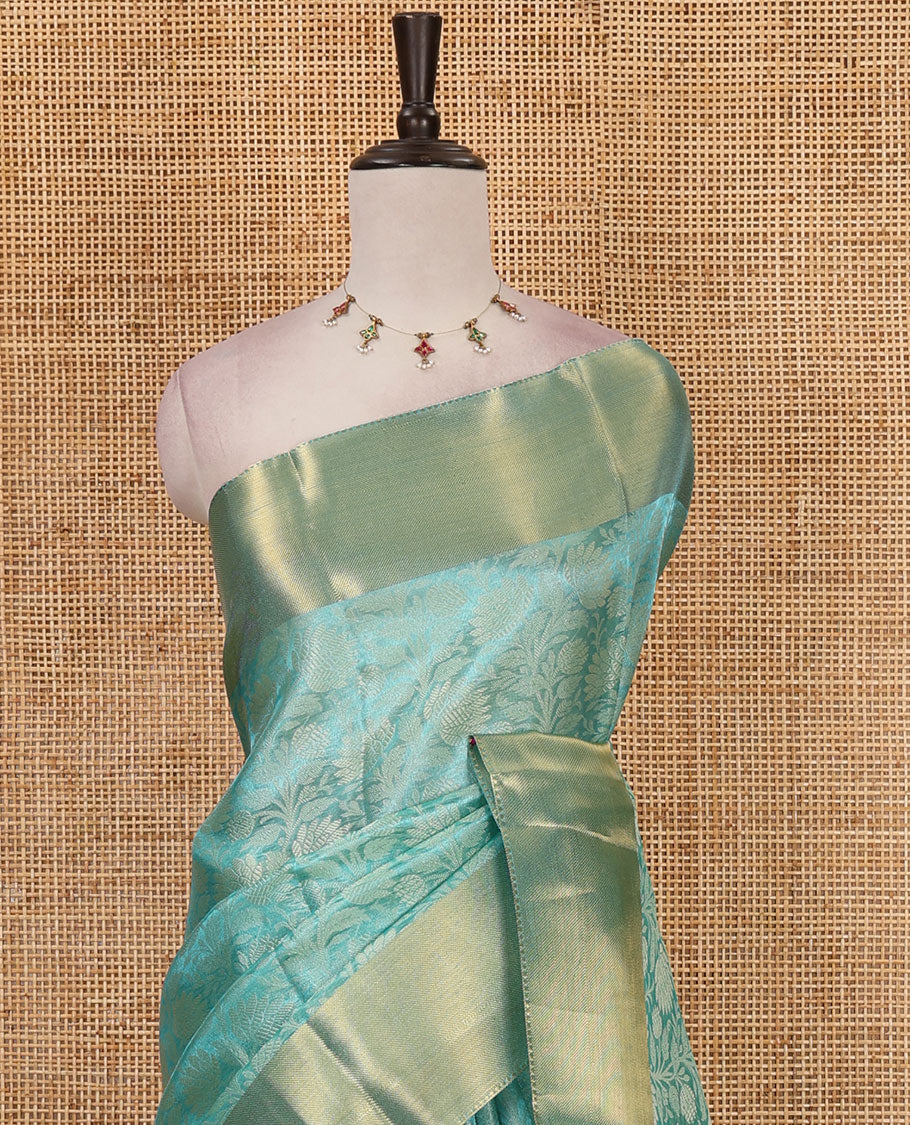 Sea green floral jaal design tissue saree, bavanji golden zari border, plain pallu & matching zari border blouse