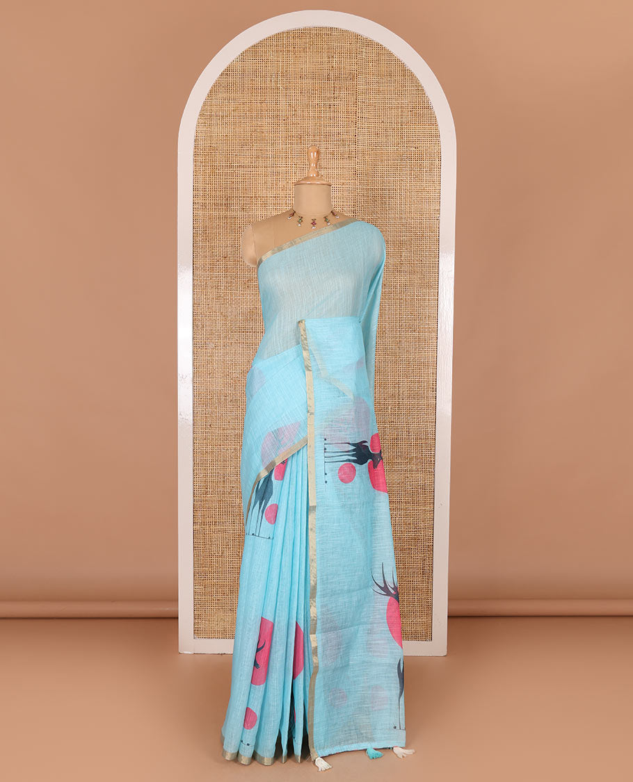 Blue sun and deer silhouette printed linen cotton saree, gold zari piping border, printed pallu, and a matching stripes printed blouse