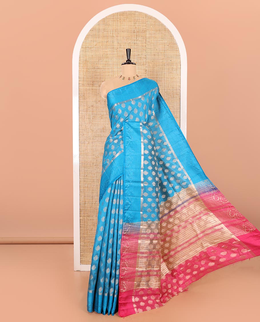 Blue Semi-Tussar Saree Bedecked with Copper Zari Floral Bud Motifs, Featuring a Floral Creeper Embossed Border, Complemented by a Contrast Pallu Adorned with Floral Bud Motifs, and Paired with a Contrast Blouse