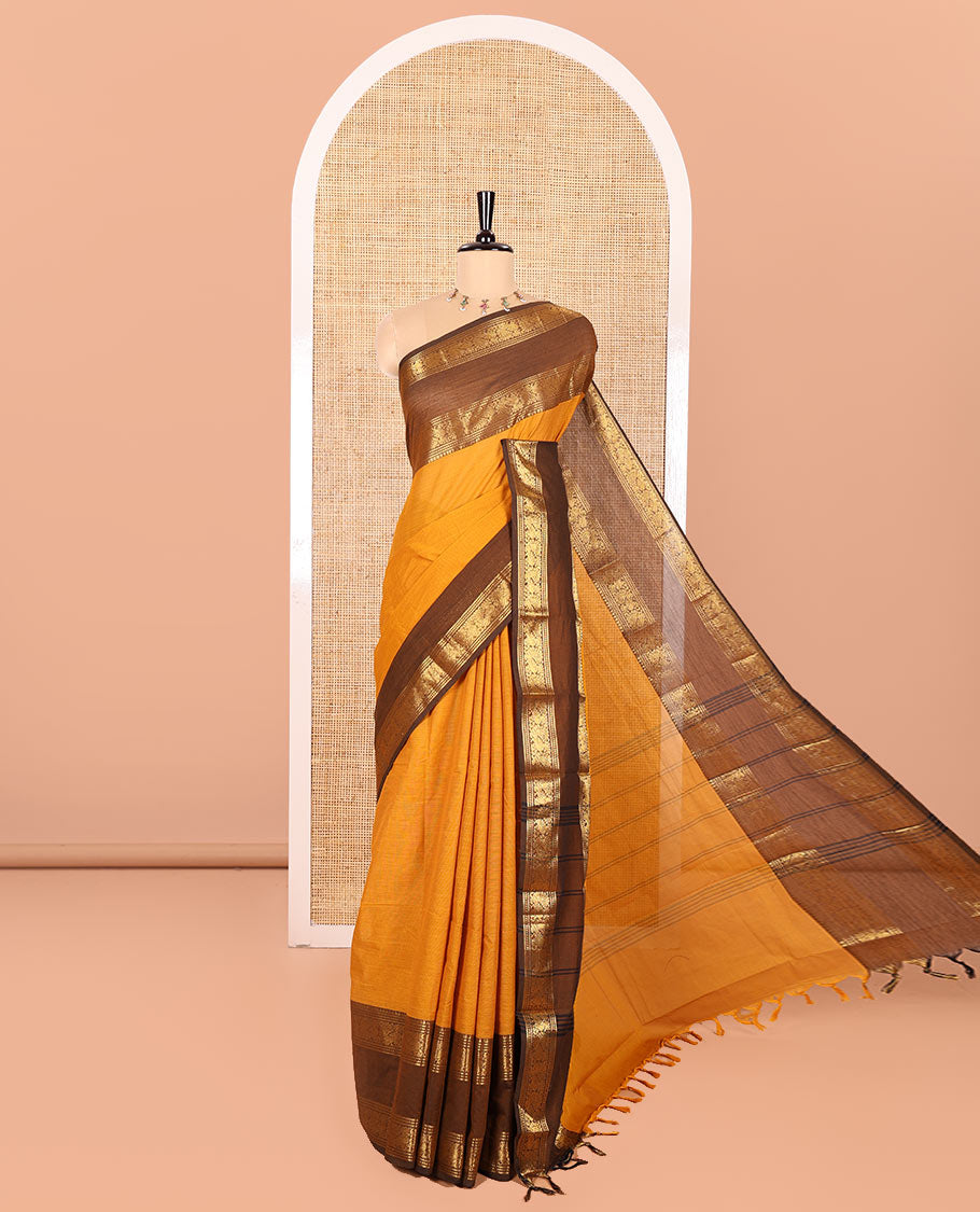 Mustard Plain Chettinad Cotton Saree, Complemented by Contrast Rettai Pettu Traditional Zari Temple Border of Peacocks, Subtly Striped Pallu, and Paired with a Matching Blouse