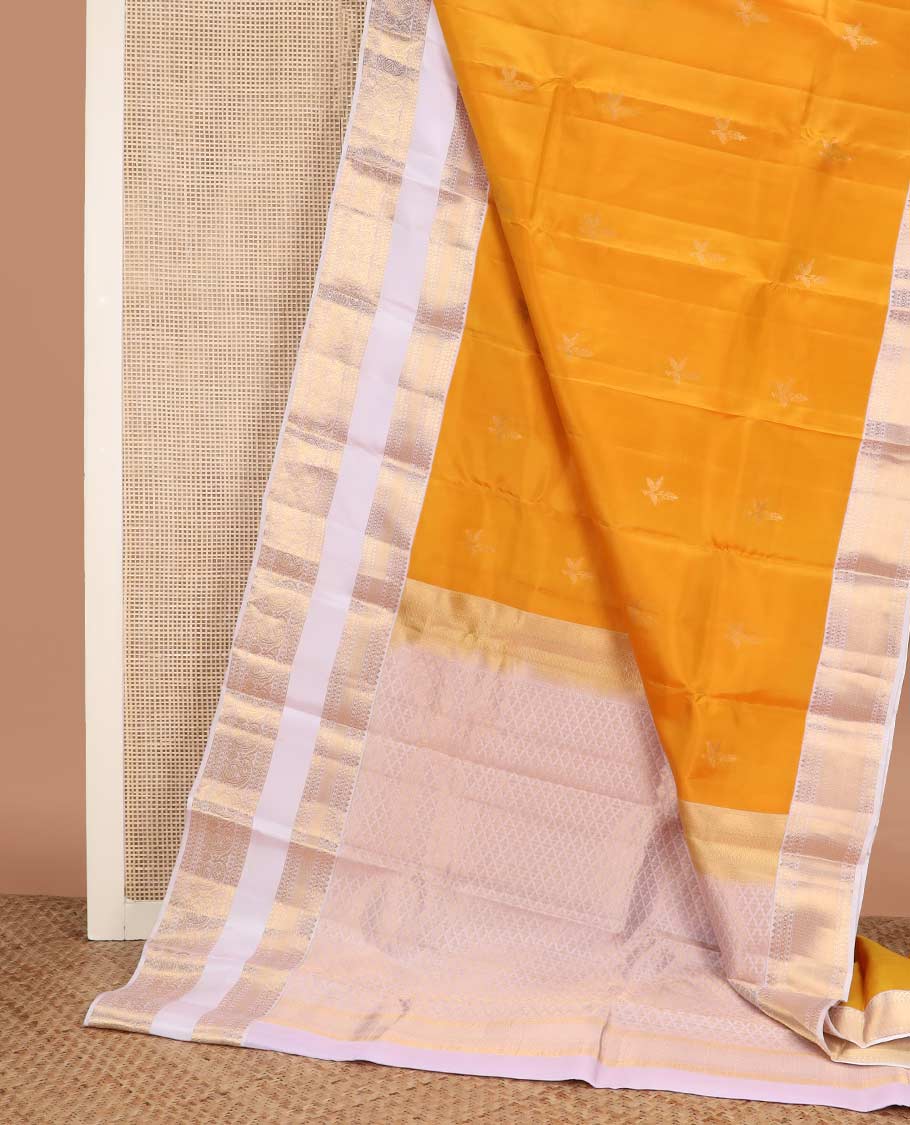 Orange zari buttas Vasundhara silk mix saree, contrast rettai pettu border of rekku, cross kamalam, and manga designs
