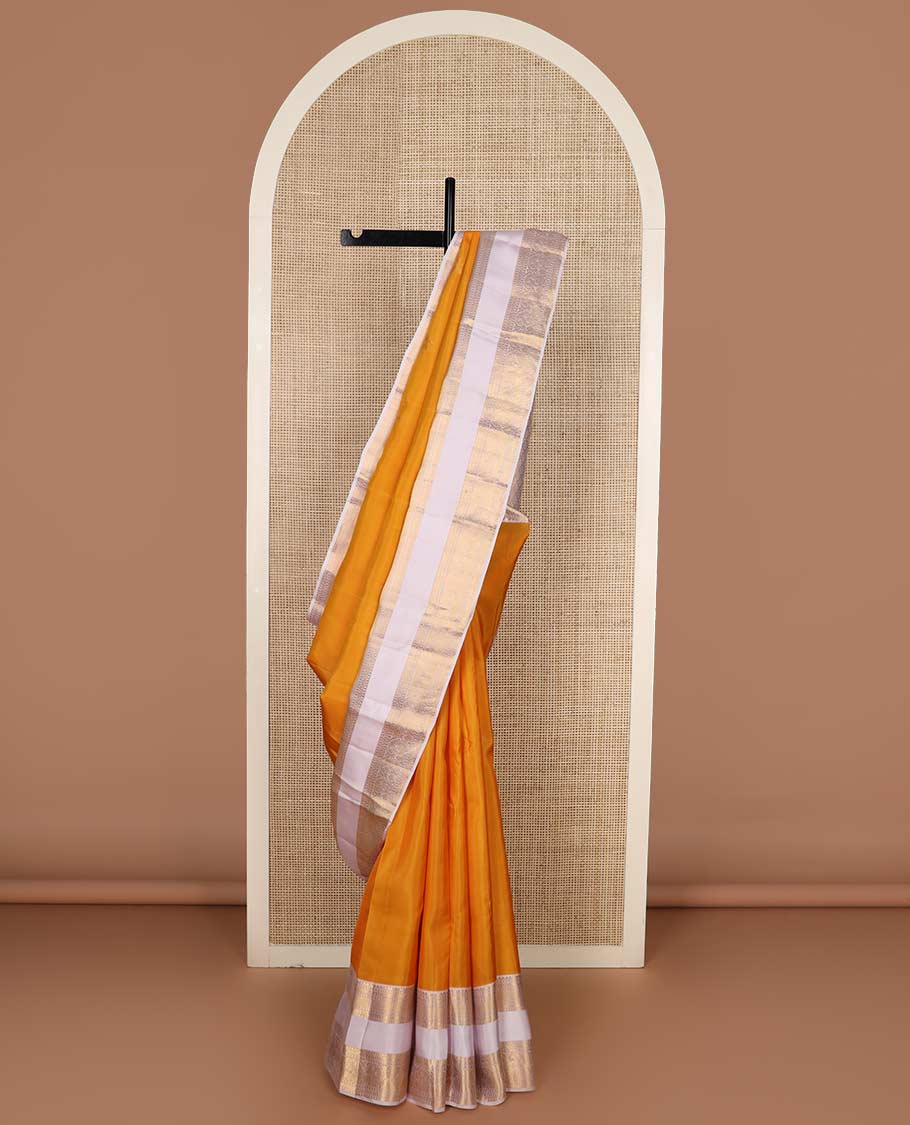 Orange zari buttas Vasundhara silk mix saree, contrast rettai pettu border of rekku, cross kamalam, and manga designs