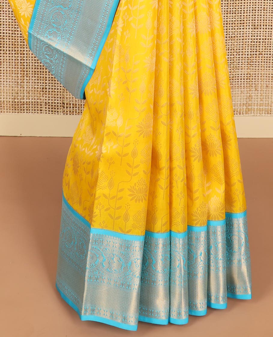 Yellow floral design kancheepuram silk saree with contrast border of thilakam mokku, banaras, muthu, paun design & zari design pallu
