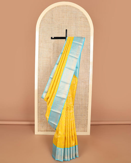 Yellow floral design kancheepuram silk saree with contrast border of thilakam mokku, banaras, muthu, paun design & zari design pallu