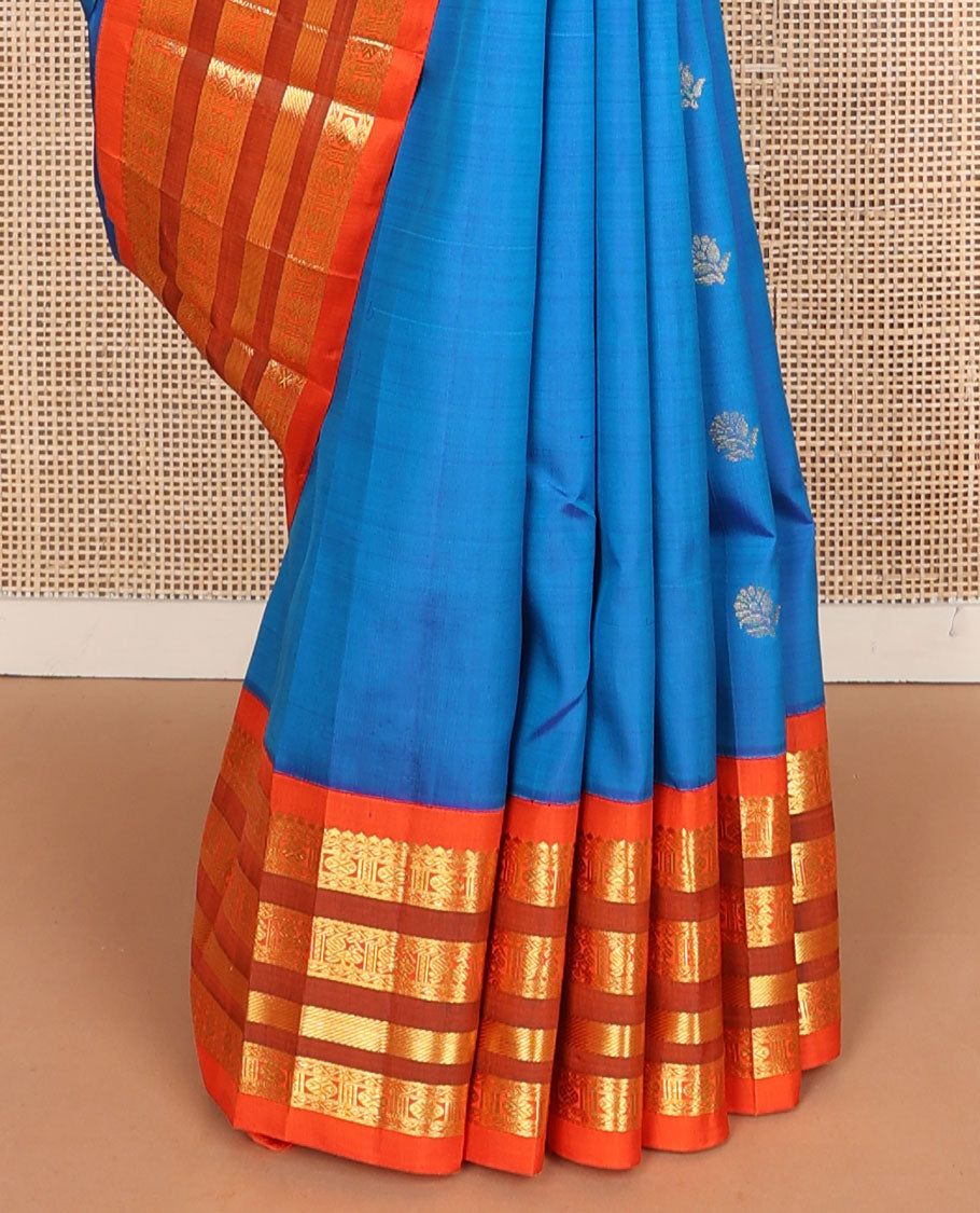 Blue buttas Kanchipuram silksaree, contrast one-sided korvai border of thilakam mokku,neli,rudraksham,mayil & banaras & manga motifs pallu