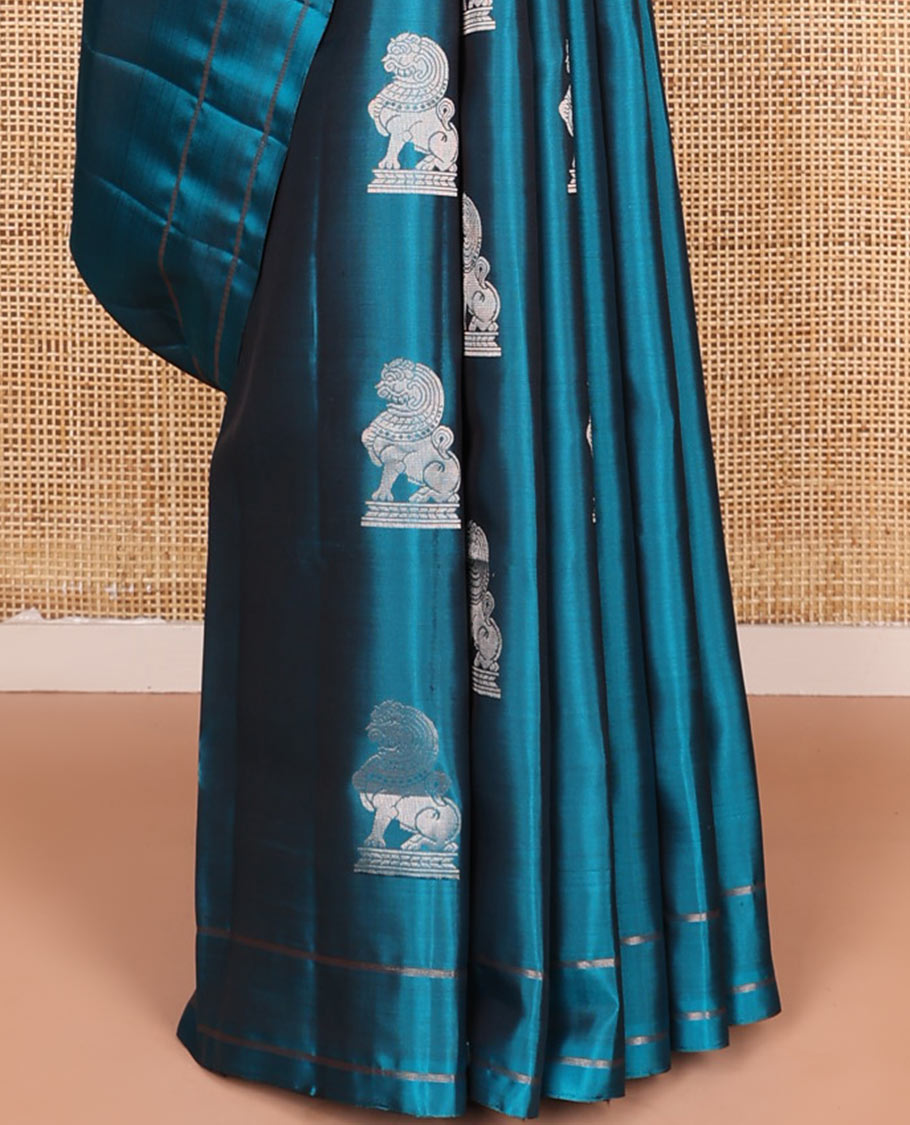 Blue singam buttas soft silk saree, zari striped border, and pallu of vanki designs