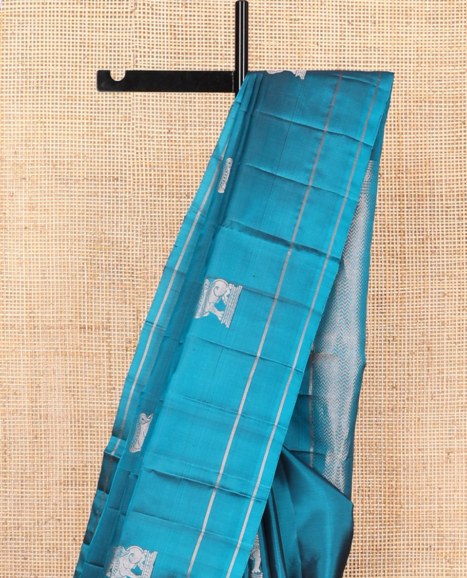 Blue singam buttas soft silk saree, zari striped border, and pallu of vanki designs