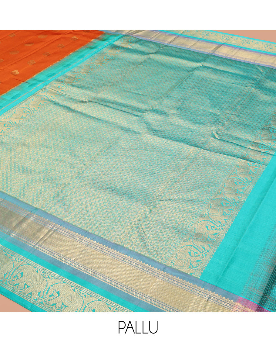 Orange Vasundhara Silk Saree Embellished with Yaanai and Poun Buttas All Over Its Body, Complemented by Zari Border of Neli, Mayil Kann, and Yaanai Designs, a Grand Pallu of Jaal Designs, and Paired with a Contrast Blouse