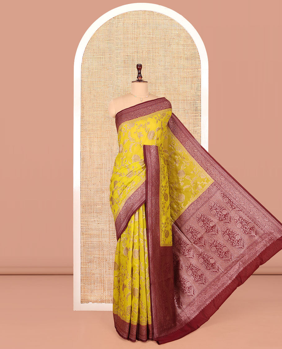 Yellow Dola Silk Saree, Artfully Detailed with Floral Jaal Design on Its Body, Complemented by Contrast Paisley Design Border, Intricately Designed Pallu, and Paired with a Contrast Blouse