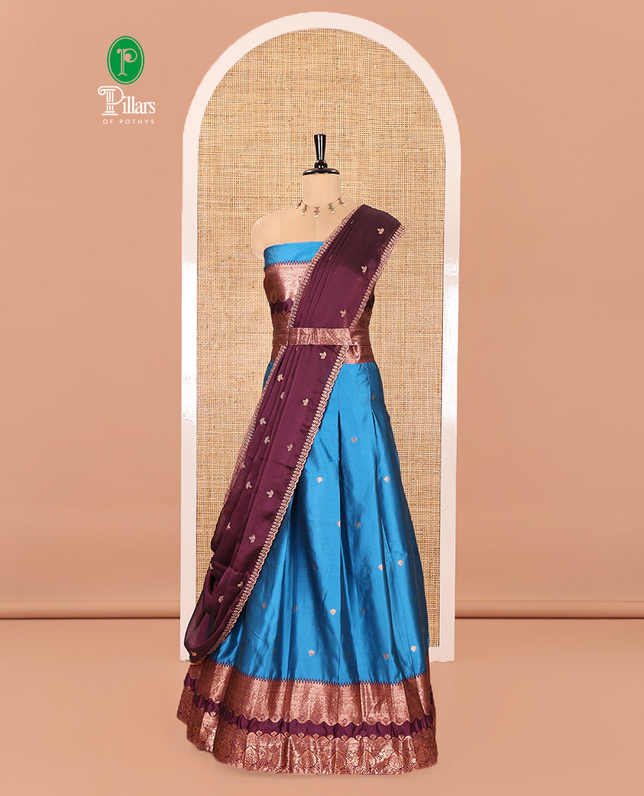 Blue-Purple Semi-Banarasi Half-Saree Mesmerized with Zari Buttas on Its Skirt, Complemented by a Contrast Traditional Zari Temple Rettai Pettu Border, Paired with a Matching Blouse, and a Satin Georgette Embroidered Scallop Dhavani