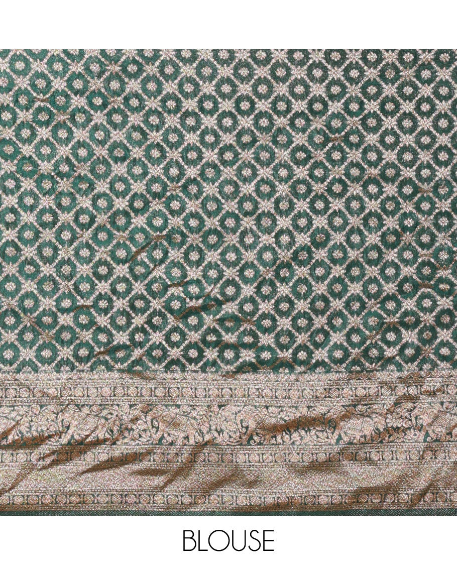 Green Semi-Banaras Khaddi Georgette, Finely Detailed with Zari Buttas All Over Its Body, Subtly Sparkled Traditional Border of Rudraksham, Elephant, and Floral Vine Designs, Pallu of a Herd of Elephants, and Paired with a Matching Blouse