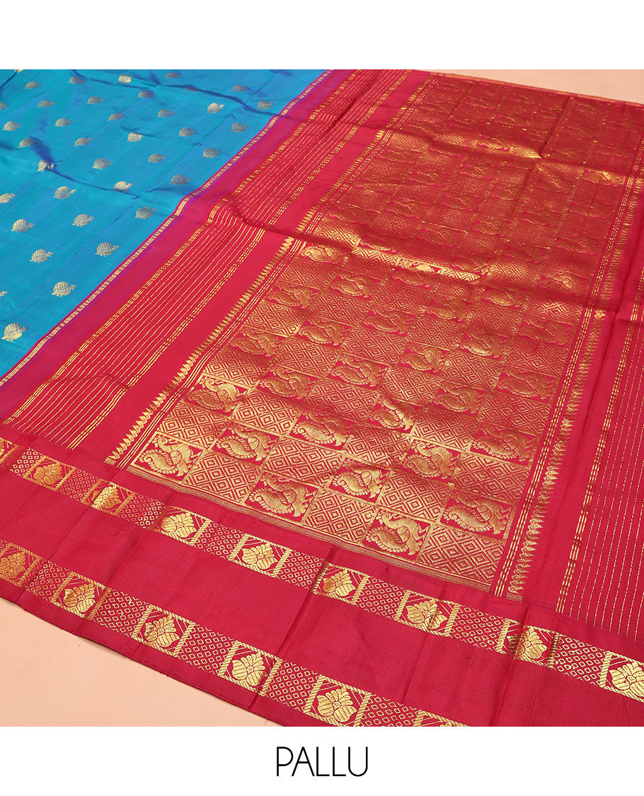 Blue Kanchipuram Silk Saree, Decked Up with Mayil Buttas on Its Body, Complemented by Contrast One-Sided Korvai Traditional Zari Border, Pallu Features Jaal and Mayil Designs, and Comes Without a Blouse
