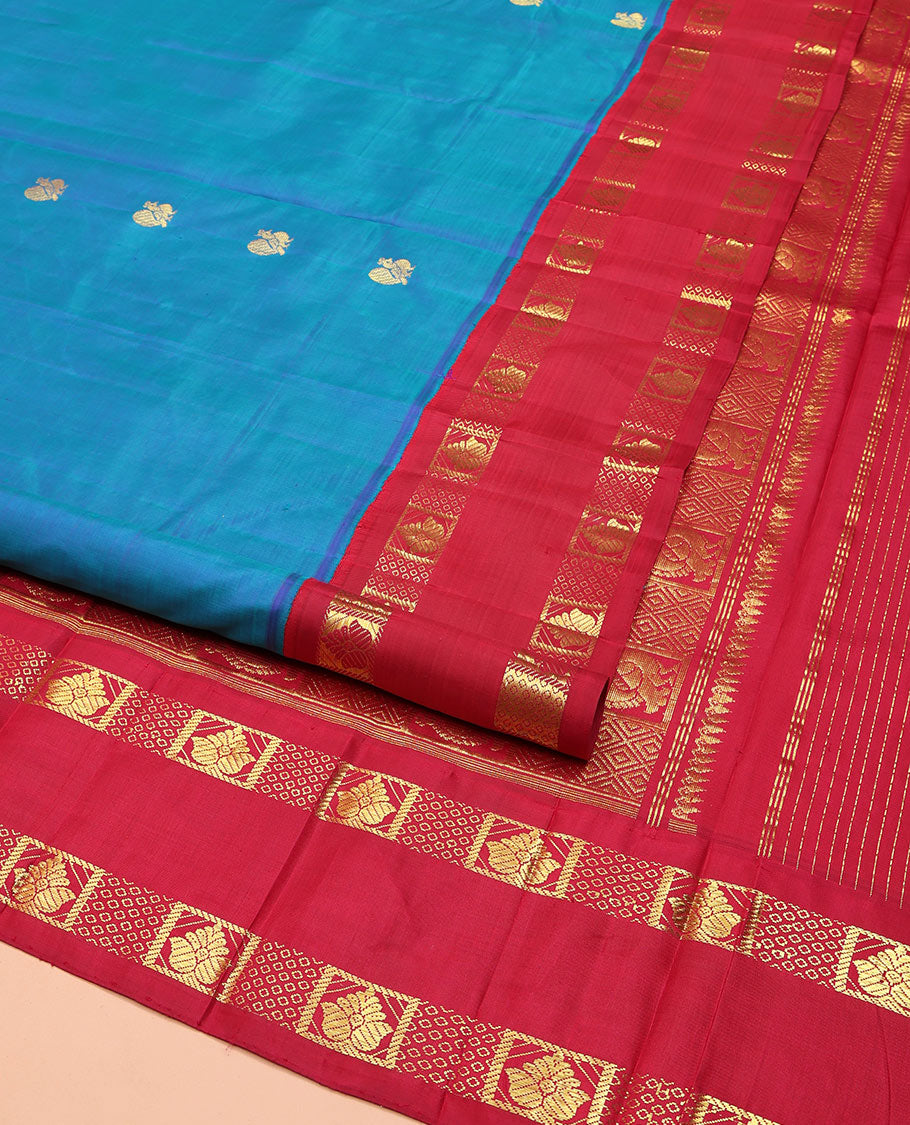 Blue Kanchipuram Silk Saree, Decked Up with Mayil Buttas on Its Body, Complemented by Contrast One-Sided Korvai Traditional Zari Border, Pallu Features Jaal and Mayil Designs, and Comes Without a Blouse